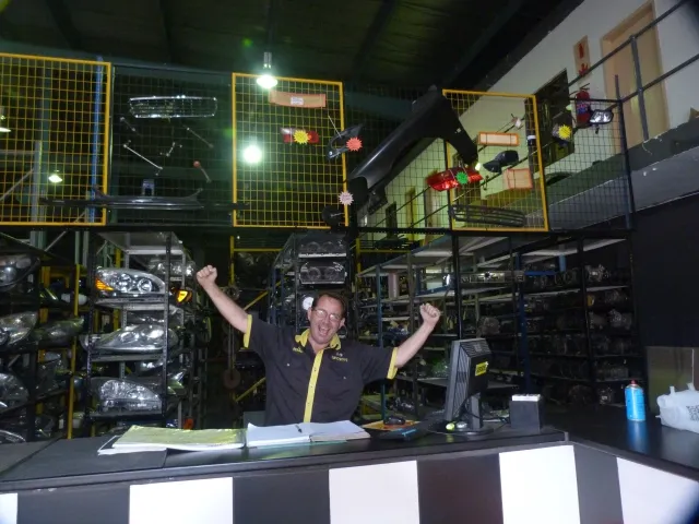 A Sparesboyz counter hand in front of the parts racking